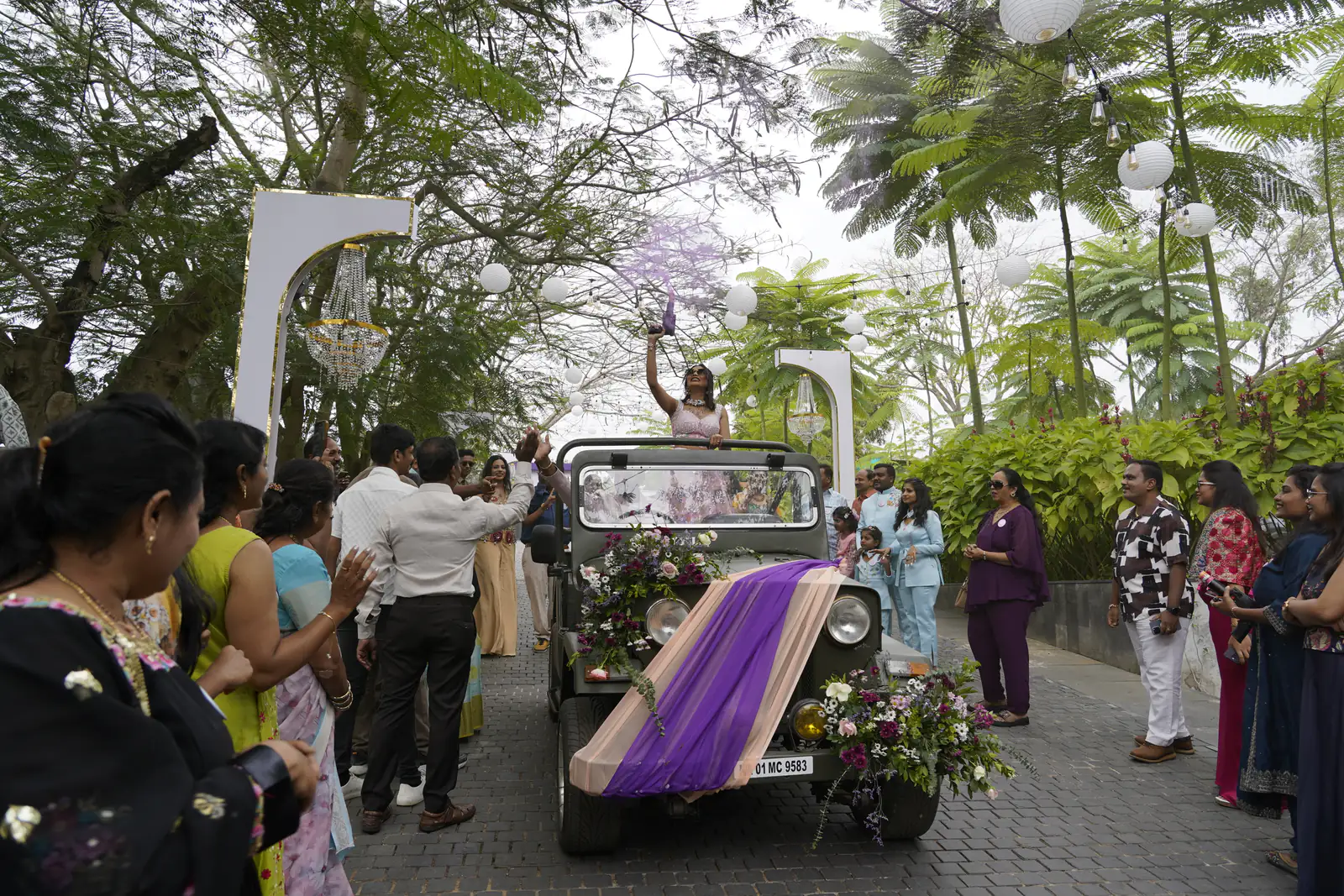 Bride arrival in a vintage jeep with crowd