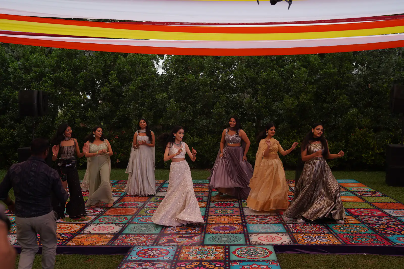 Sangeet dance performance on a printed tiled stage