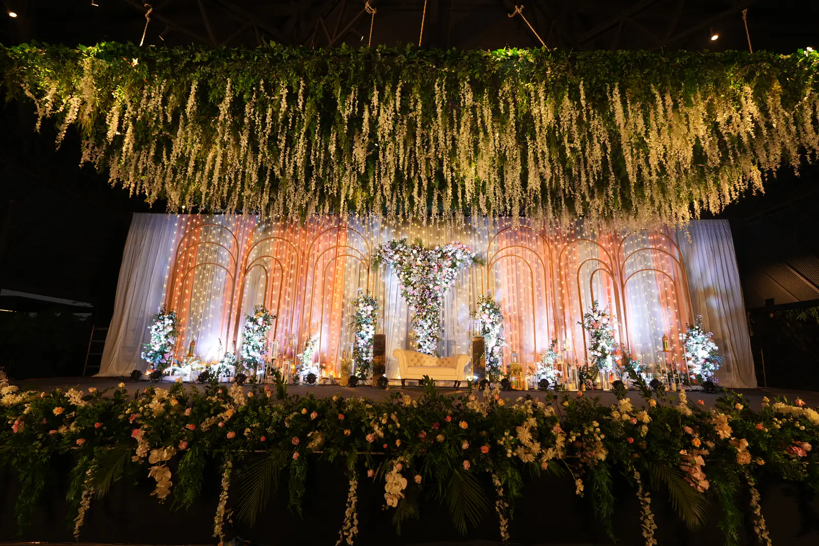 Reception stage with hanging florals